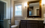 Bathroom with vanity and rustic mirror