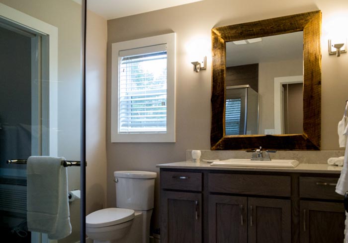 Bathroom with vanity and rustic mirror