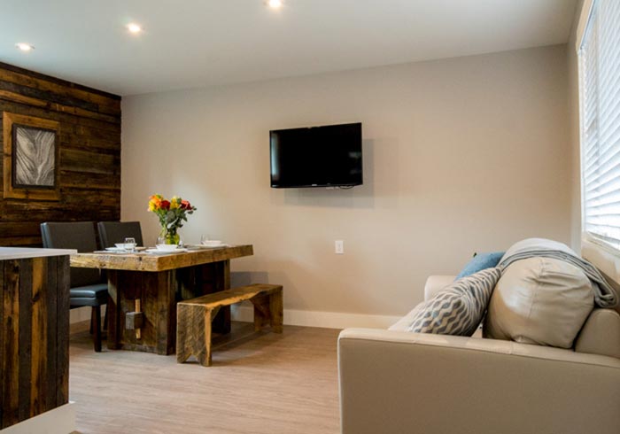 Living room with couch and table and TV mounted on wall