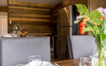 Closeup of dining table and flowers with kitchen in background