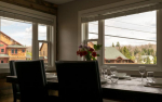 Large dining table looking out of two windows