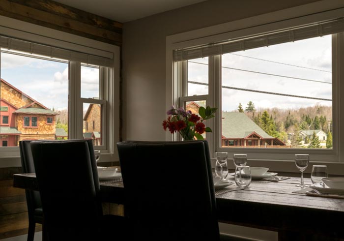 Large dining table looking out of two windows