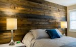 Bedroom with barn board wall with bed and nightstands with lamps