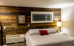 Bed with barn wood wall with window