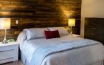 Bedroom with white bedspread and red pillow