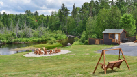 Cabin, firepit with chairs a wood swing