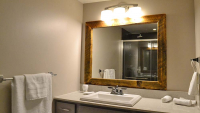 Wood framed mirror in bathroom