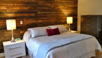 Bedroom with wood plank wall